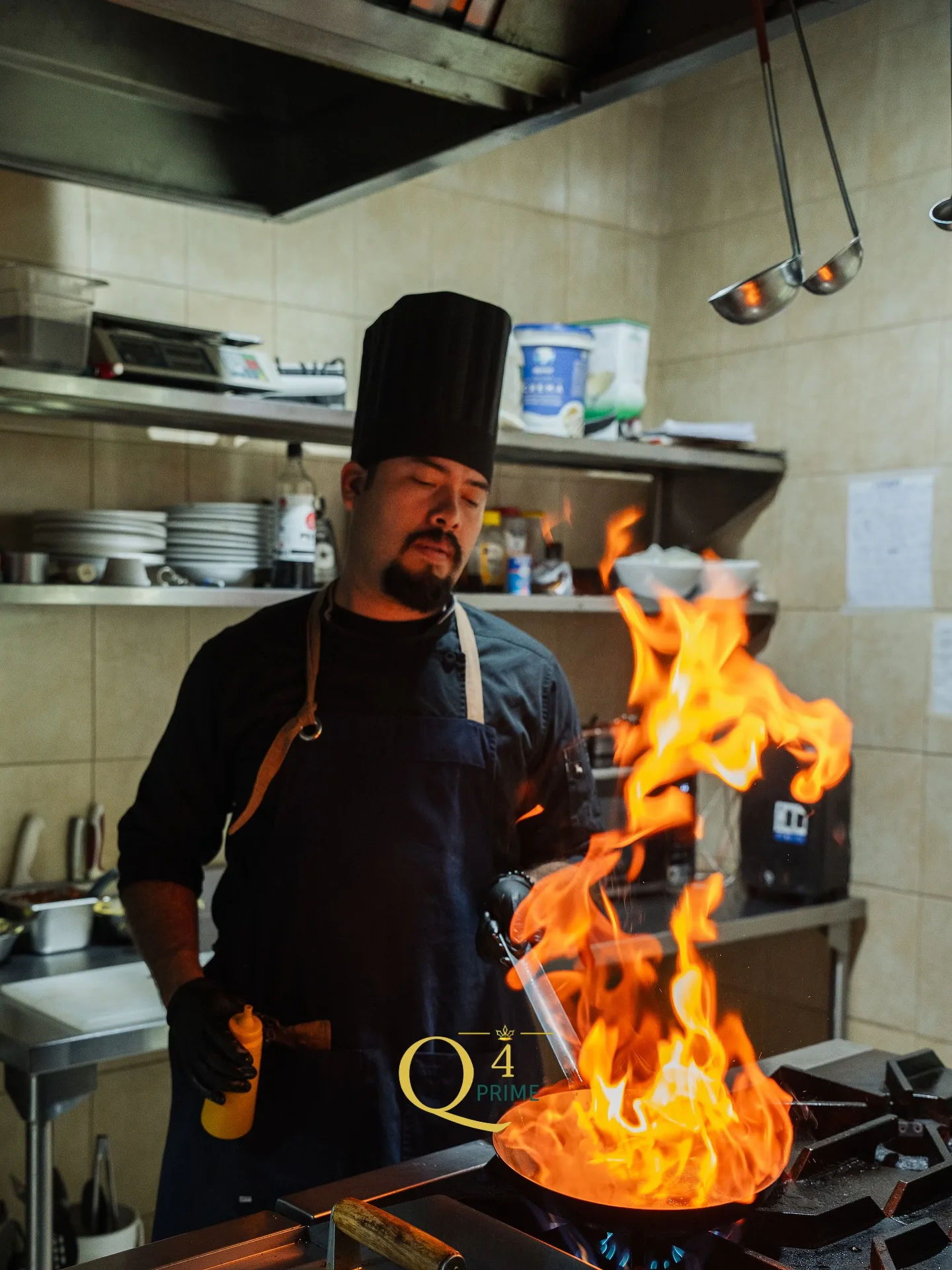 Chef de Q4tro flameando un platillo en la cocina